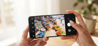 Person editing a photo on a smartphone, illustrating AI-powered photo editing tools on phones sold in Nigeria