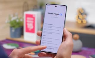 Xiaomi phone held in hand from behind showing camera and frame