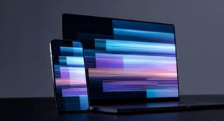 Editorial-style image showing smooth UI motion trails on a smartphone and laptop display