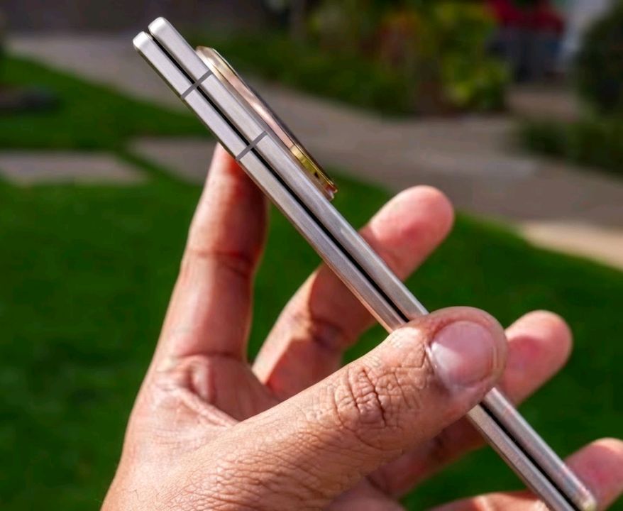 Honor Magic V5 held in hand showing its slim folded profile