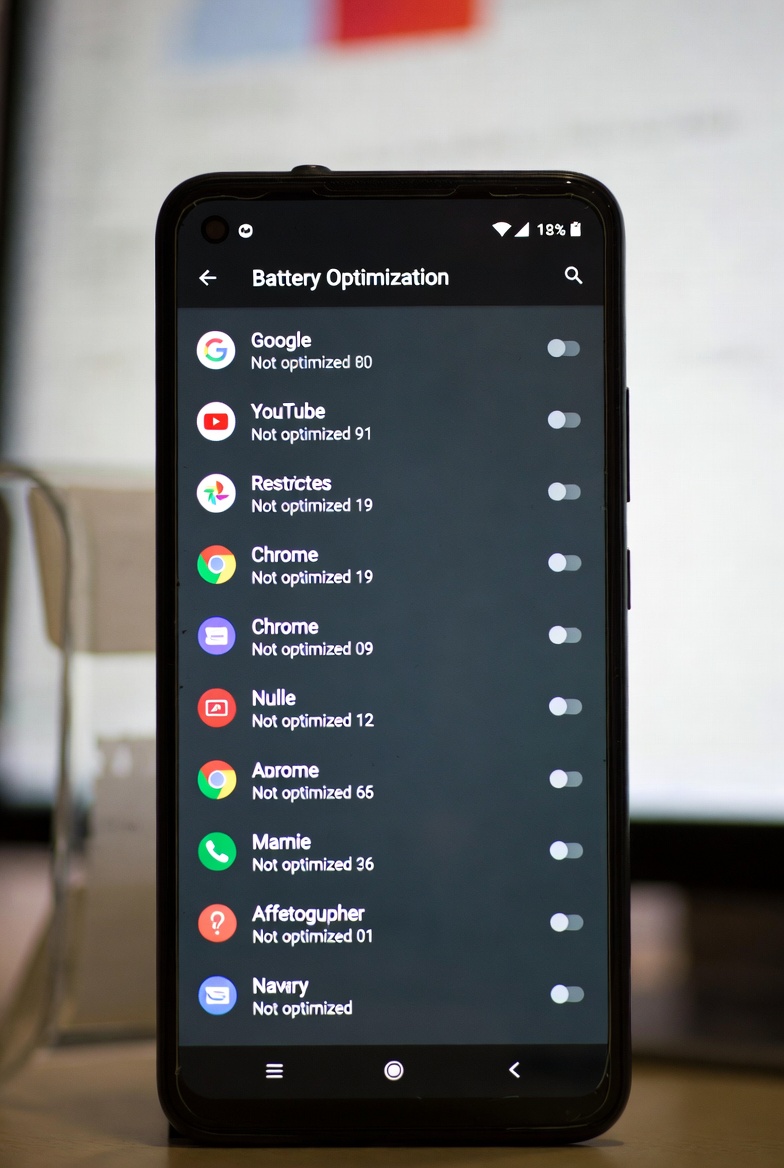 Battery optimization settings on Android showing restricted background apps list