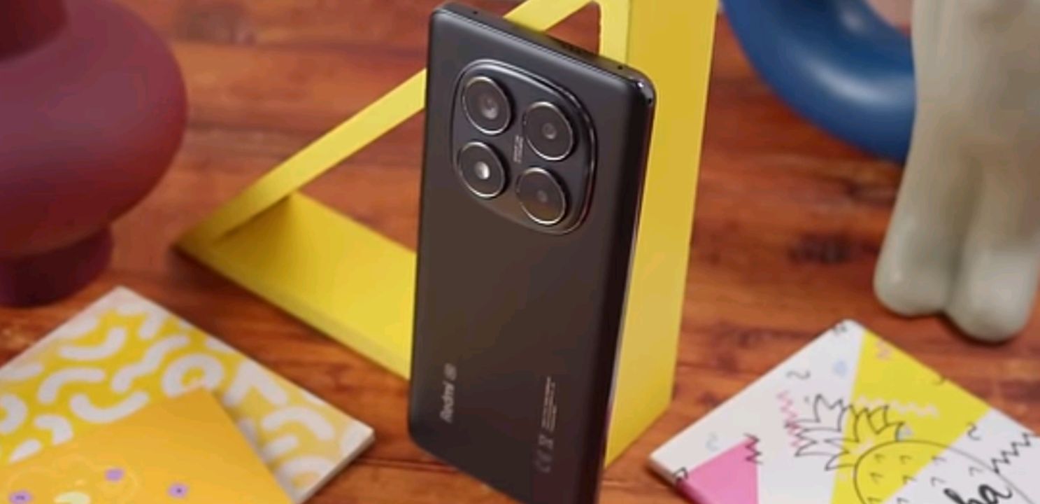 Five Xiaomi and Redmi smartphones under $300 laid out side by side on a wooden desk