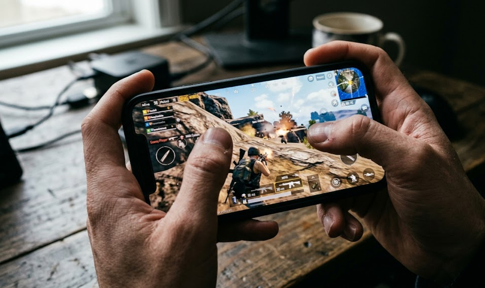 A gaming smartphone showing PUBG Mobile battle royale gameplay on screen