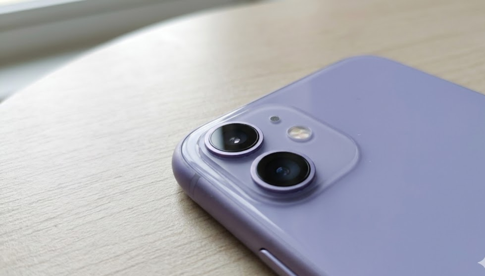 iPhone 11 display showing camera system on a table in natural light