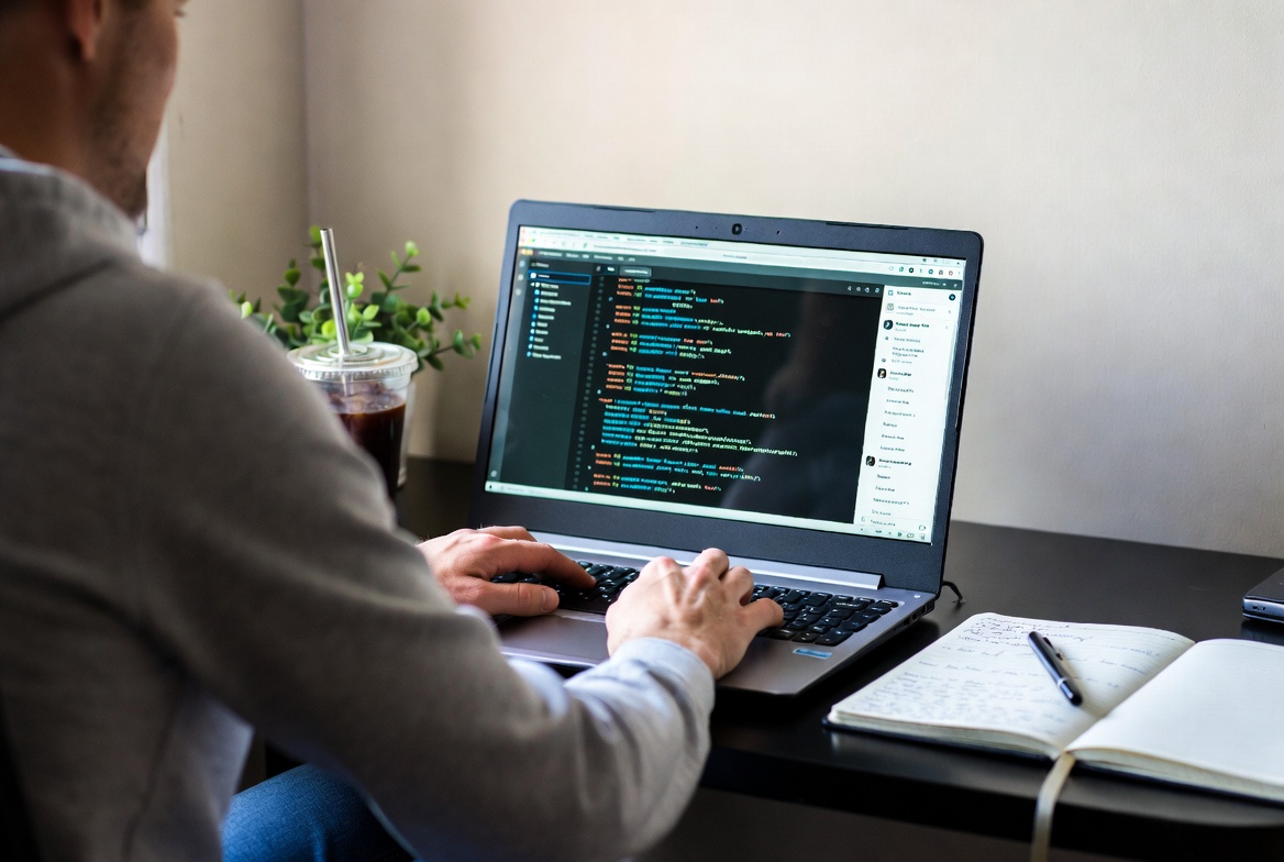 iSamuel working on ReviByte content and code workflow at a desk