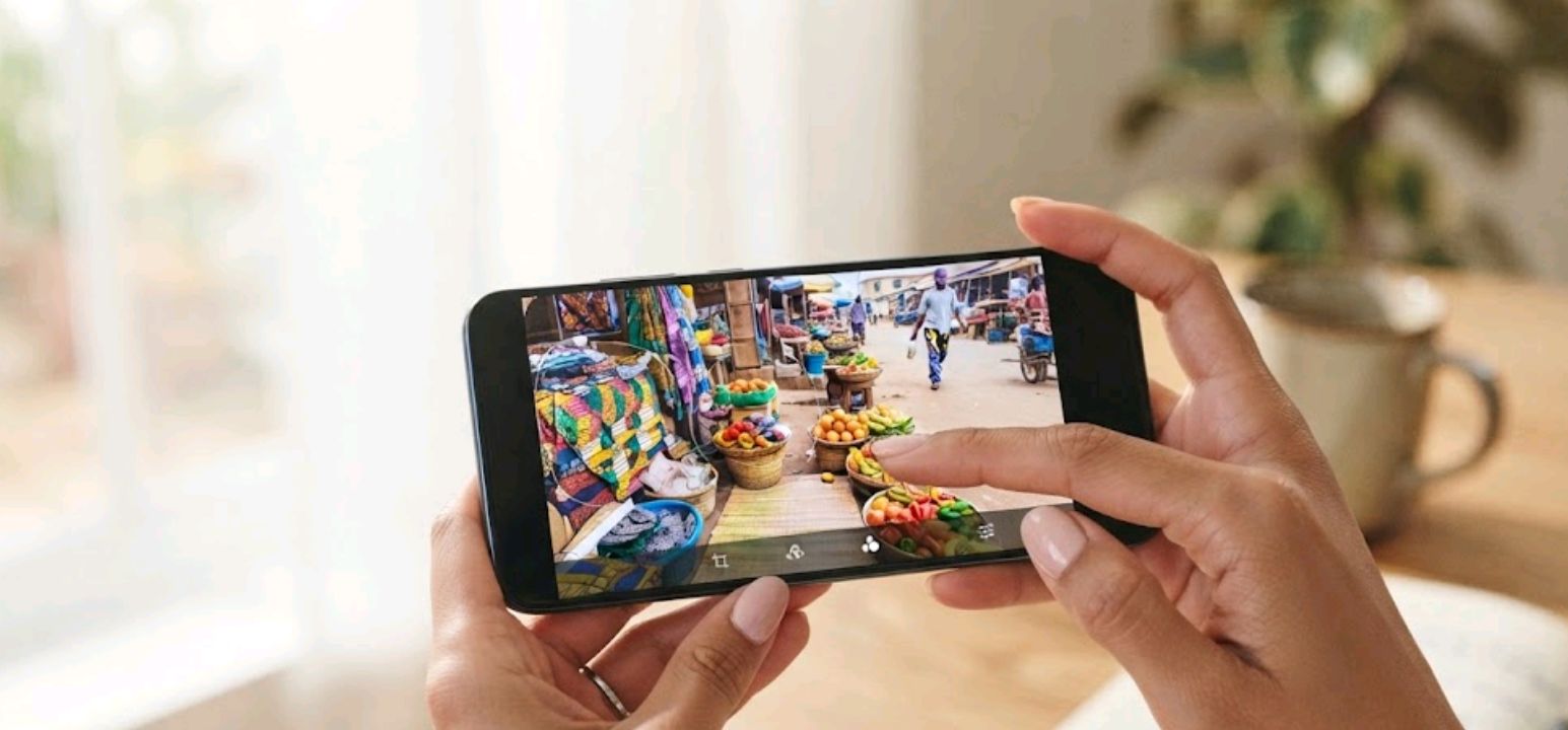 Person editing a photo on a smartphone gallery app, removing a background object