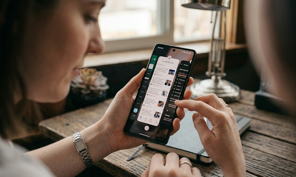 Person using Android phone with multiple apps open