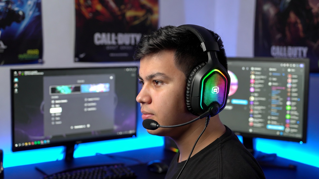 Gaming setup with headset and glowing monitor displaying Call of Duty menu screen